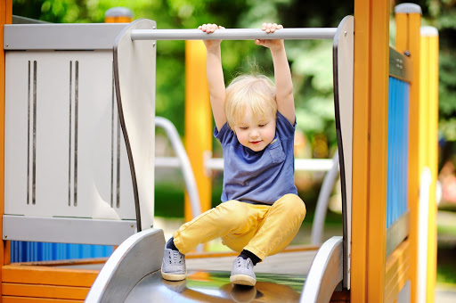 a child about to slide down a slide