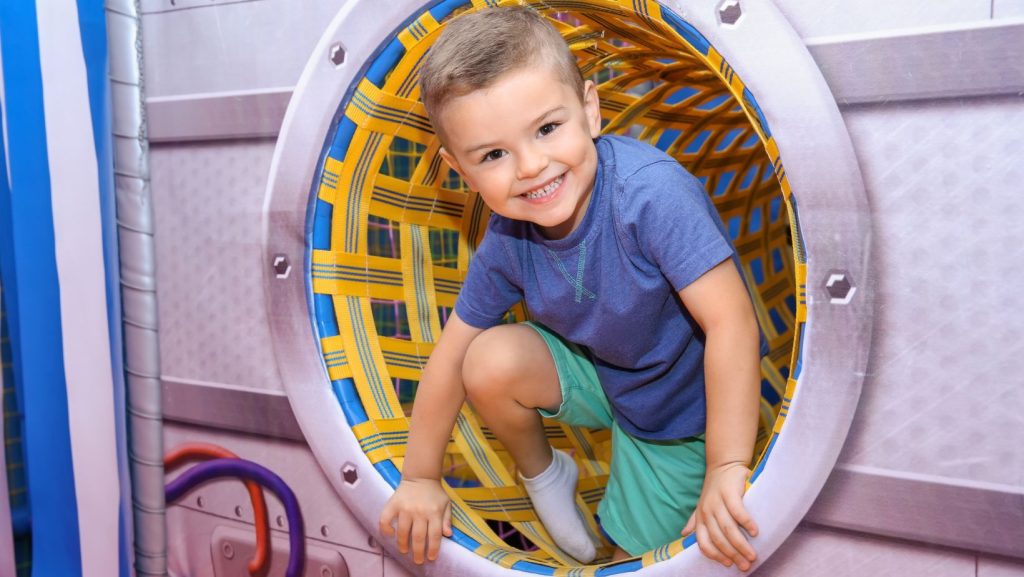 Child smiling while playing in a playground