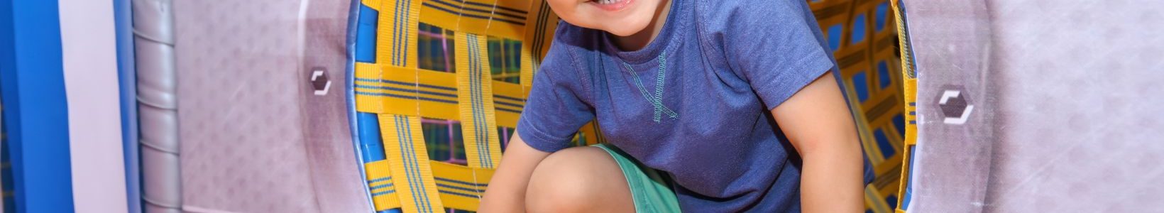 Child smiling while playing in a playground